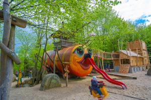 un parque infantil con un gran tobogán de elefantes naranja en Berggasthof Butterberg, en Bischofswerda