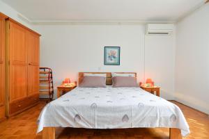 a bedroom with a large bed and two tables at Apartment Anton 2083 in Premantura