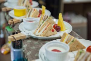 a table with plates of sandwiches and cups of coffee at Lusihan B&B in Yuchi