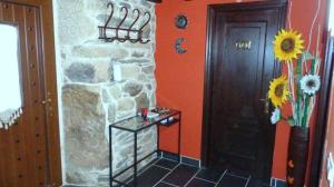 a room with a stone wall and a door at Casa Das Airas in Sarria