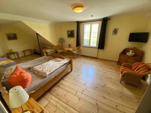 a bedroom with a bed and a living room at Museumsherberge Glashütte in Baruth