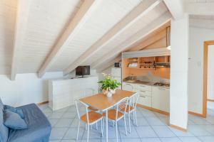 a kitchen and dining room with a table and chairs at Residence Ascot in Cattolica