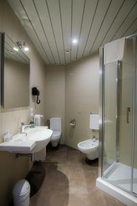 a bathroom with a sink and a shower and a toilet at Tuscany Inn in Montecatini Terme