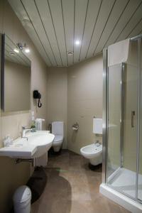 a bathroom with a toilet, sink, and shower at Tuscany Inn in Montecatini Terme