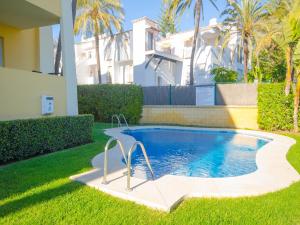 a swimming pool in the yard of a house at Apartamento Vistamar in Marbella