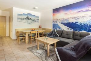 a living room with a couch and a table at Peaceful Rogla Apartment in Zreče