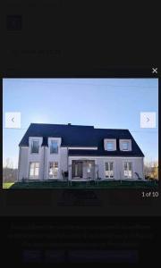 日安的住宿－Gite de Standing Gien，一张带两扇窗户的白色房子的照片