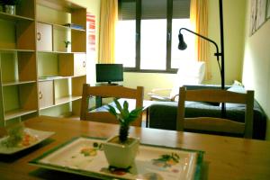a living room with a table and a couch at La Refierta in Cangas del Narcea