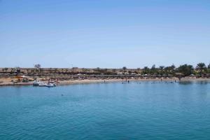 a view of a beach with boats in the water at Xperience St. George Sharm El Sheikh in Sharm El Sheikh