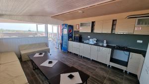 a large kitchen and living room with a pepsi machine at Casa Decebal in Eforie Nord
