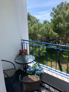 a balcony with a table and chairs and flowers on it at Hotel Elu Iris in Split