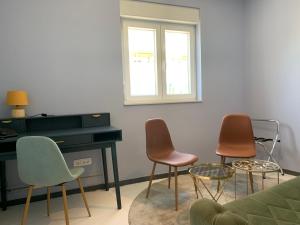 a living room with three chairs and a piano at Hotel Elu Iris in Split