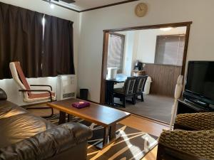 a living room with a couch and a table at Hakuba Ski Condos in Hakuba