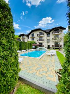 an exterior view of a house with a swimming pool at Августин in Solochyn +76 photos