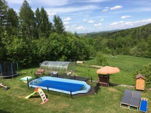 a backyard with a swimming pool and a tent at WyspaDrzewoDomek in Kamionna