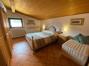 a bedroom with two beds and a window at Cèsa MeSa in Canazei