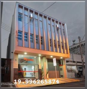 a building on a city street with a building at Hotel Princeton in Piracicaba