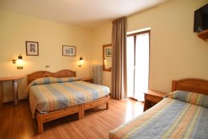 Postel nebo postele na pokoji v ubytování Albergo Bucaneve
