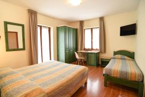 Posteľ alebo postele v izbe v ubytovaní Albergo Bucaneve