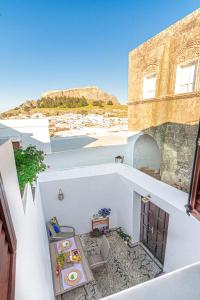 a view from a balcony of a building with a table at Villa Dafni - Lindos in Lindos