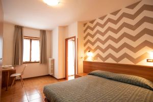 Postel nebo postele na pokoji v ubytování Albergo Bucaneve