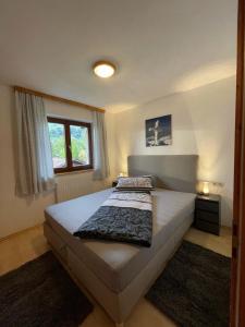 a bedroom with a bed and a window at Haus Mariandl in Westendorf