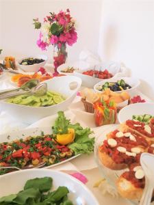 a table topped with bowls of different types of food at Medimar Hotel in Kaş