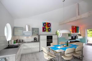 a kitchen with a blue table and chairs in it at Ruegen-Beach-House-Haus-Palstek in Göhren