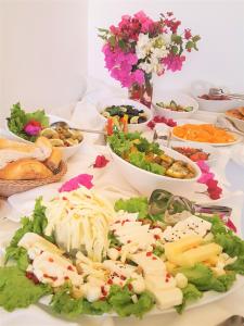 a table topped with lots of different types of food at Medimar Hotel in Kaş