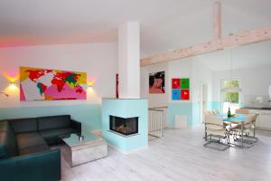 a living room with a couch and a fireplace at Ruegen-Beach-House-Haus-Schostek in Göhren