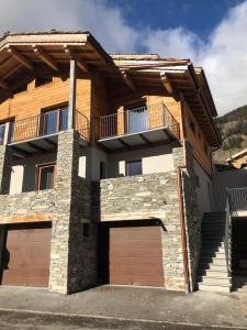 a house with a balcony and a garage at NOUVEAU ! Chalet Grand Croix - Haut Standing - 8, 10 pers in Lanslebourg-Mont-Cenis