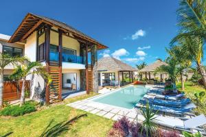 a villa with a swimming pool and a house at Mythic Suites & Villas in Grande Gaube