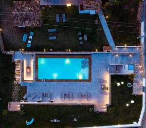 an overhead view of a swimming pool at night at Giardini Del Golfo in Balestrate