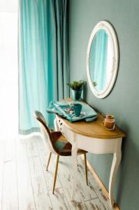 a dressing table with a mirror and a chair at Seaside apartments in Roja