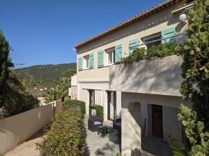 a house with a staircase leading up to it at La villa Acacia in Coti-Chiavari