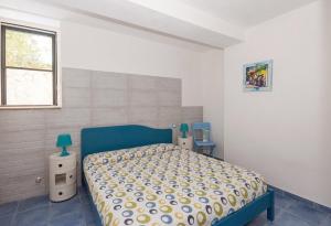 a bedroom with a bed and two night stands at B&B Tor Di Lupo in Mattinata