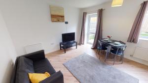 a living room with a couch and a table at The Central Lodge II in Dartford
