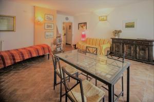 a living room with a glass table and chairs at Villadina Farm in Colico