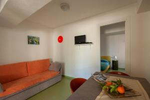 a living room with a couch and a table at B&B Tor Di Lupo in Mattinata