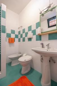 a bathroom with a toilet and a sink at B&B Tor Di Lupo in Mattinata