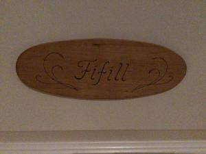 a wooden sign that says flight hanging on a ceiling at Purola Farm Guesthouse in Saarijärvi