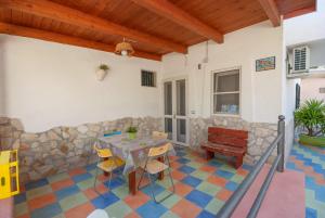 a dining room with a table and chairs at B&B Tor Di Lupo in Mattinata