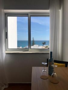 a window with a view of the ocean from a table at Sea Light Apartment Vista Mar - Luz, Lagos in Luz