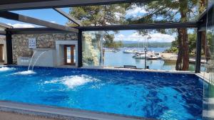 a swimming pool with a view of the water at Boutique Resort Villa VISTA in Malinska +33 photos