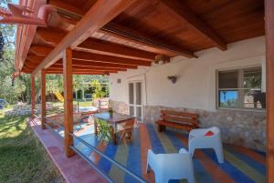 a patio of a house with a table and chairs at B&B Tor Di Lupo in Mattinata