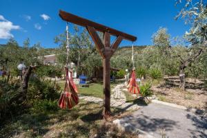 a swing set in a garden with trees at B&B Tor Di Lupo in Mattinata
