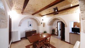 - un salon avec une table en bois dans l'établissement Capodigallo Holiday Trullo Monte Santo, à Alberobello