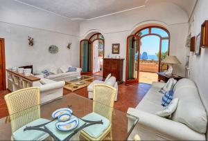a living room with couches and a table and chairs at Suite Casa Mia in Capri