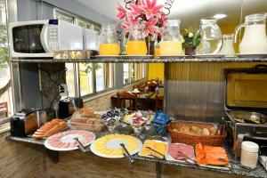 a buffet of food on a counter in a kitchen at Hotel Rio Claro in Rio de Janeiro