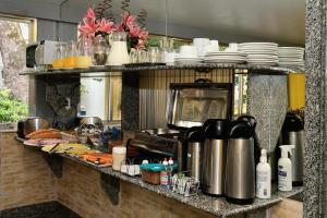 a kitchen with a counter with dishes on it at Hotel Rio Claro in Rio de Janeiro